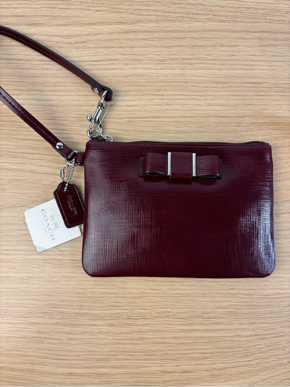 Coach Darcy Patent Leather Bow Small Wristlet in “Sherry” Wine Color NWT